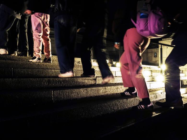 Close-up of legs of visitors walking up Huntington Avenue Entrance steps