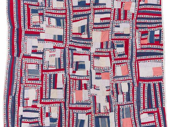 Red, white, and blue quilt made from pieced strips of solid and printed ("Vote") cotton.