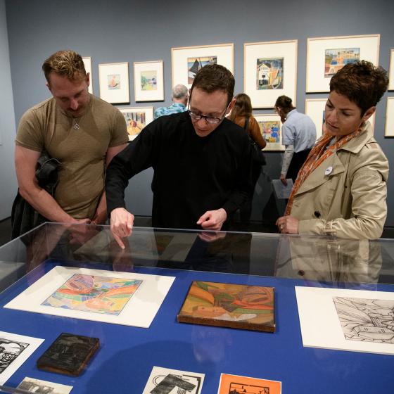 Curator Edward Saywell shows visitors through the 