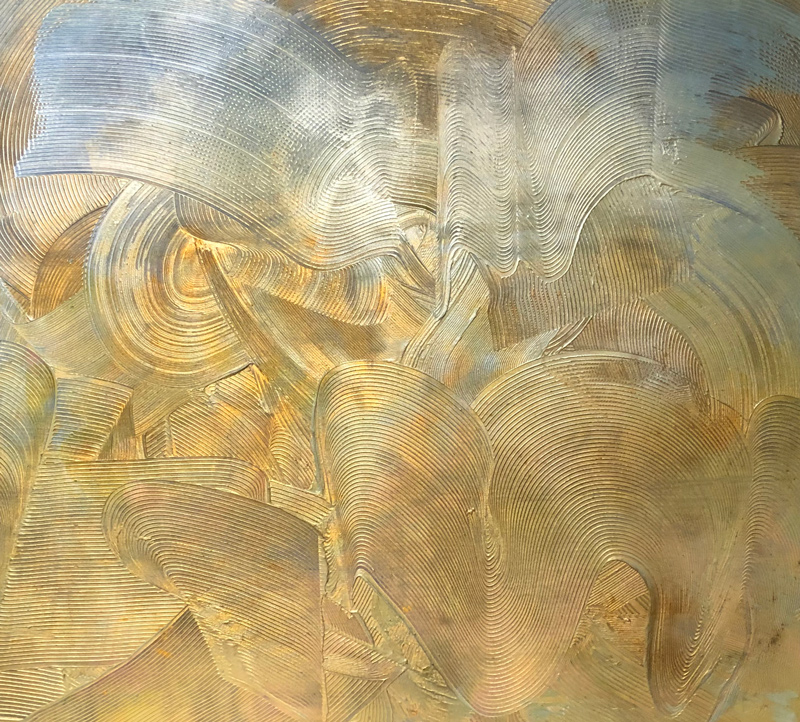 A gold painting with a raked path snaking across it.