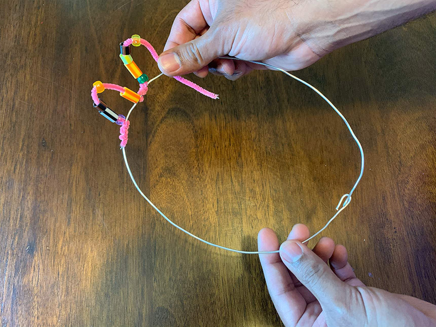wrapping pipe cleaner with beads around the front of the aluminum wire crown