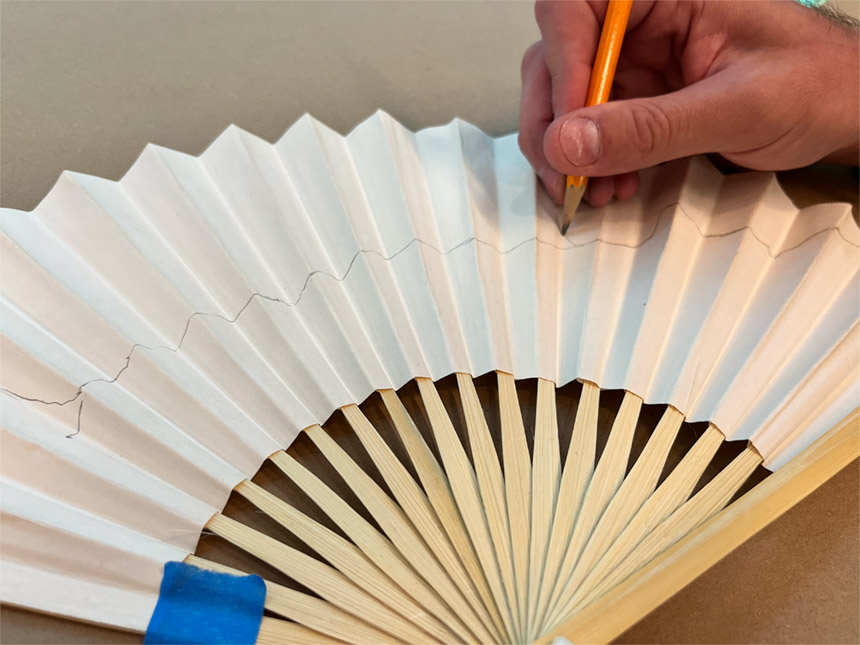 Using pencil to draw on fan