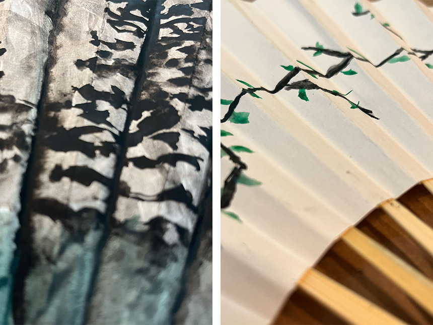 Details of painted fan surface depicting trees and budding branches