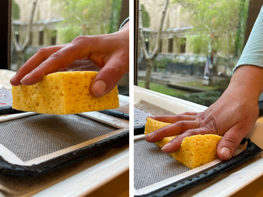 pressing sponge on the screen of mould to absorb water from pulp