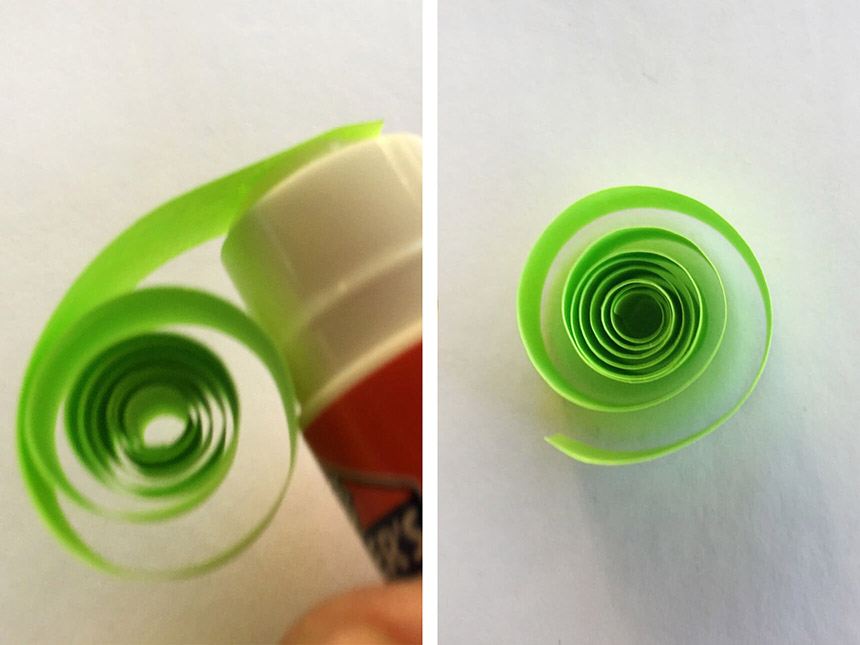 using a gluestick to apply glue onto edge of rolled-up neon paper strip
