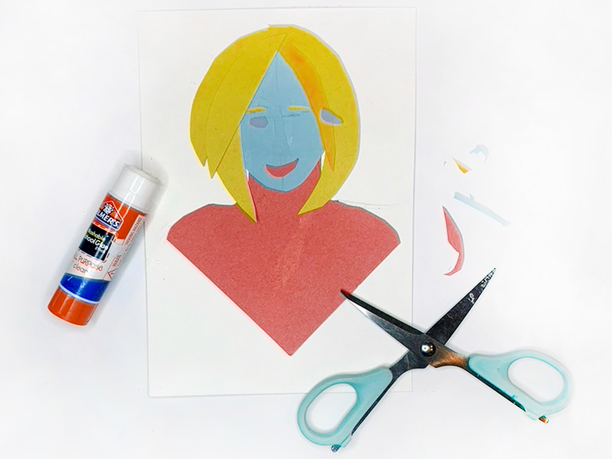 cutting smaller pieces of construction paper to use as facial features on portrait, such as eyebrows and eyes