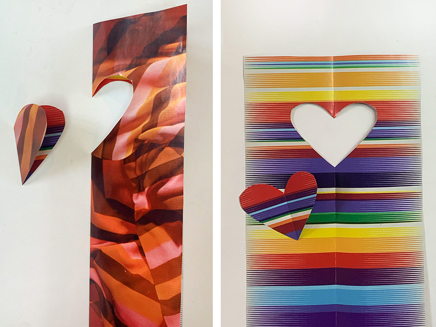 symmetrical heart shape cut out from folded paper with colorful pattern
