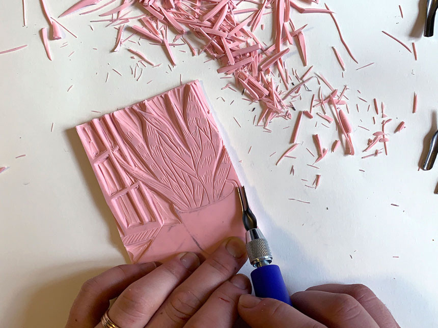 Using a different blade on linoleum cutter to carve different types of lines into block
