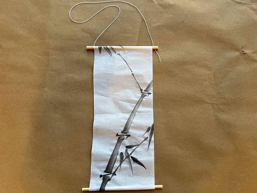 Tall scroll with black ink painting depicting bamboo with leaves