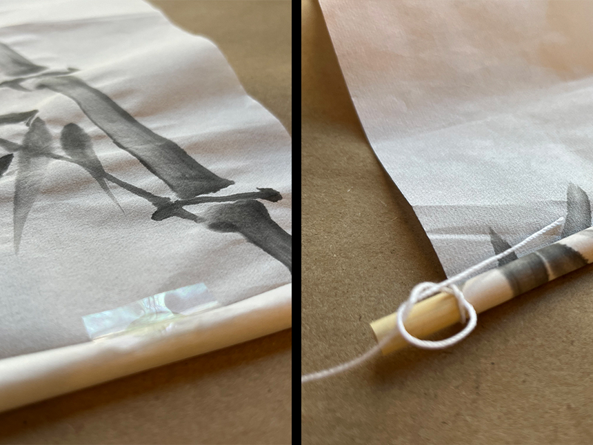 bottom edge of rice paper rolled up around dowel and secured with another glue dot; string tied to the end of dowel