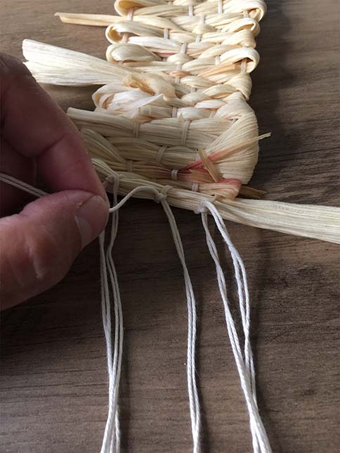 tying fringes of weaving to adjacent fringes