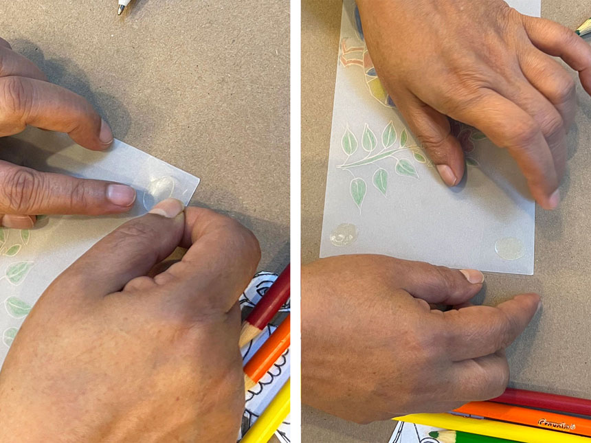 flipping peacock drawing over and applying glue dot to corner