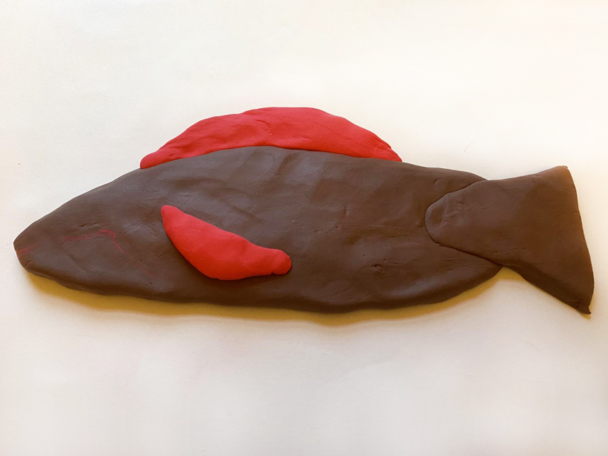 two half-oval clay shapes attached to large oval clay piece