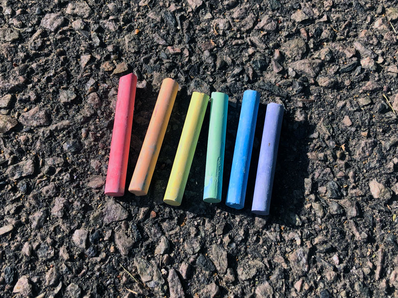 different colored chalk on asphalt