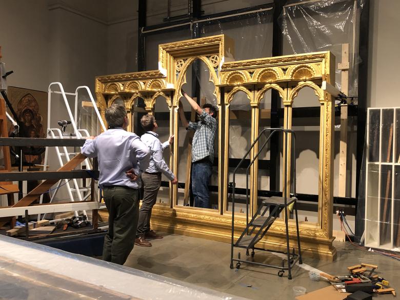 Conservators assembling the elaborate reproduction frame for an Italian altarpiece