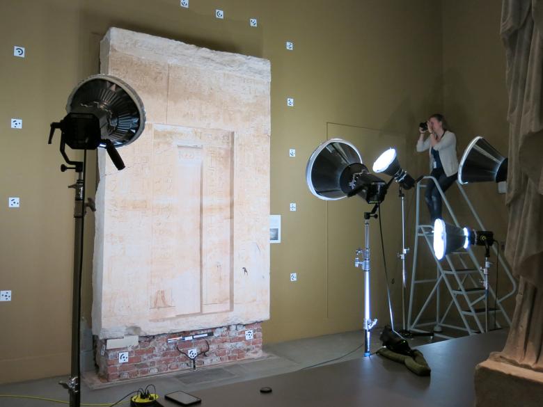 Conservator capturing images for photogrammetry of an ancient Egyptian false door