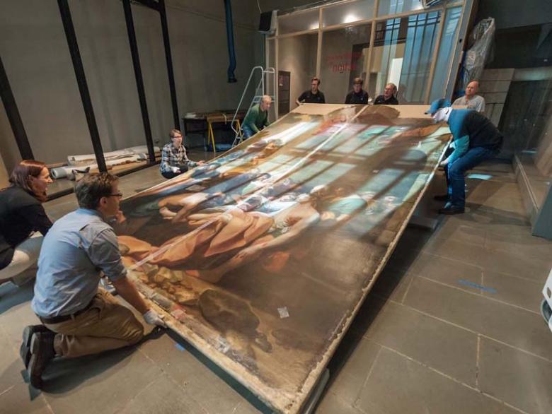 Oversize painting being lifted into upright position