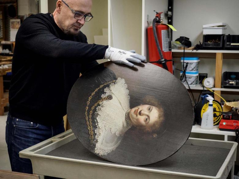 Collections care specialist preparing painting for transport