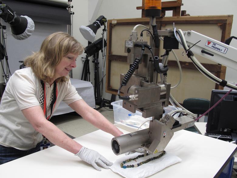 Research scientist positioning an object for X-ray fluorescence analysis