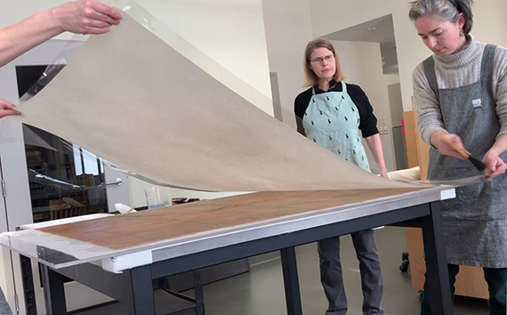 Application of new lining on Chéret poster