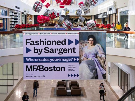 Large "Fashioned by Sargent" banner ad hanging from second floor railing in shopping mall