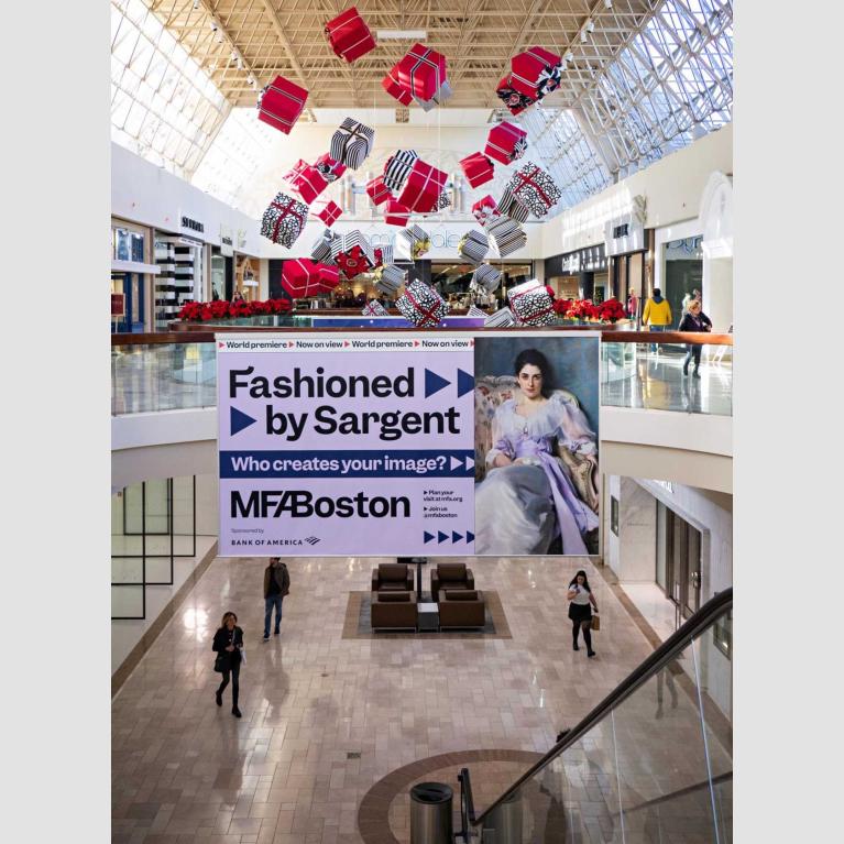 Large "Fashioned by Sargent" banner ad hanging from second floor railing in shopping mall