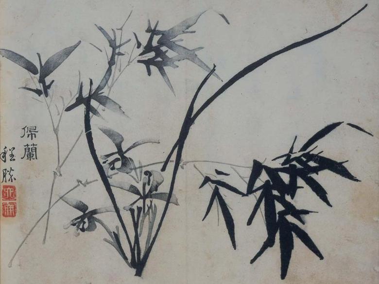 An ink and paper drawing of bamboo leaves with Chinese characters on the left-hand side.