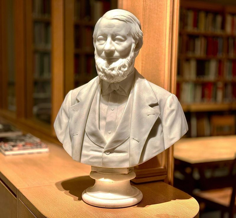 White marble bust of a man with a beard.