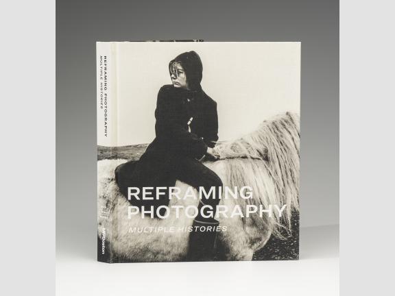 Book cover for Reframing Photography: Multiple Histories. A young person in black sitting on a white horse. They look over their shoulder.