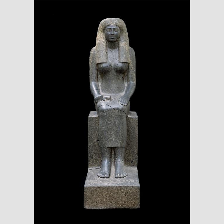 Large gray statue of seated woman