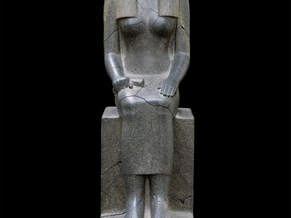 Large gray statue of seated woman