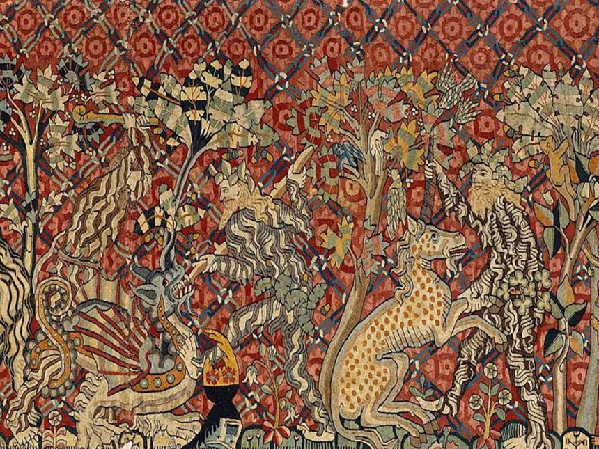 detail of tapestry depicting men fighting dragon and unicorn