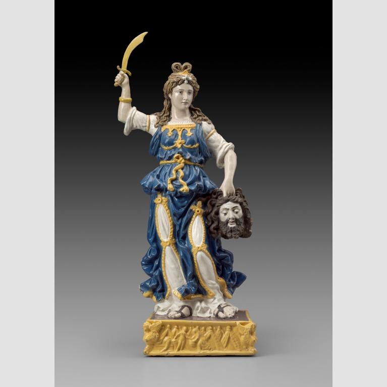 A terracotta sculpture of Judith with a sword in her right hand and the head of Holofernes in her left.