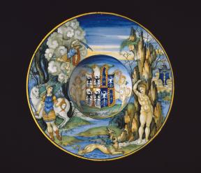 A painted plate depicting the myth of Perseus and Andromeda on the edge with the artist's coat of arms in the middle. 