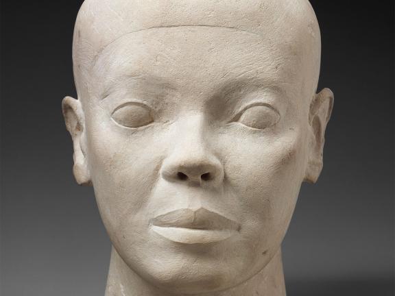 White limestone bust of man's head.
