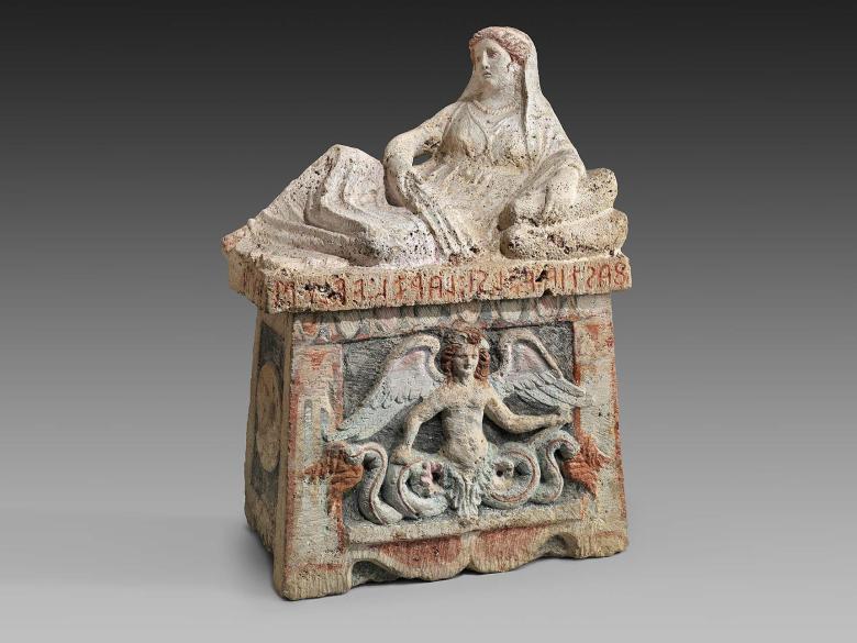 sarcophagus or large urn with figure of reclining woman on lid and angel on side