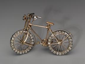 A small bicycle brooch with diamond-encrusted wheels.