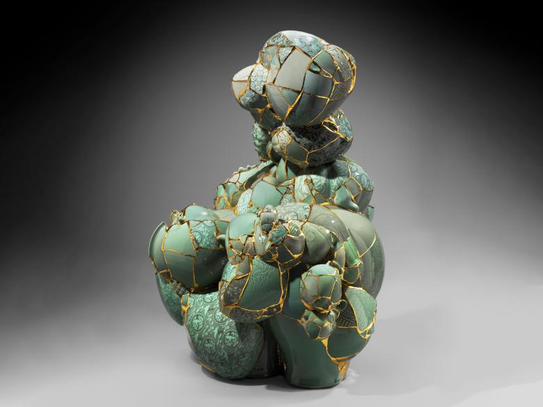 Irregularly shaped sculpture made of fragments of celadon joined together with epoxy and gold