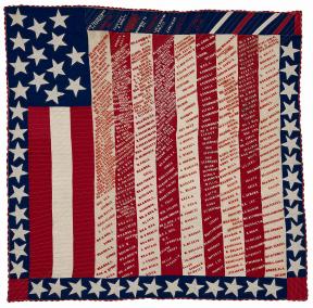 Red, white and blue quilt with stars, stripes and text