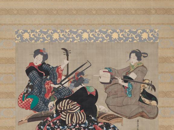 A hanging silk scroll depicting three women sitting and playing instruments. 