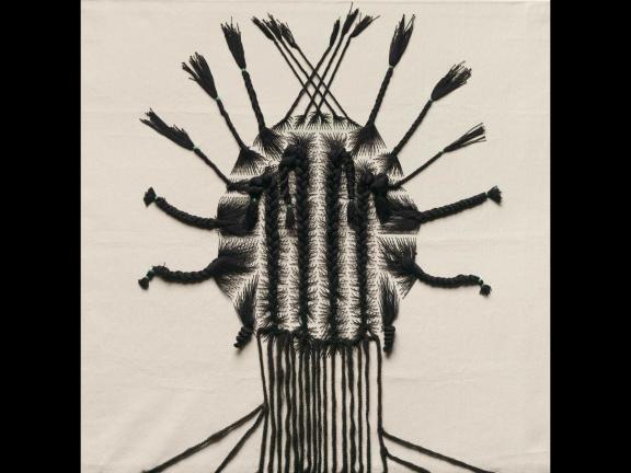 embroidery of the back of a persons head with a braided hairstyle