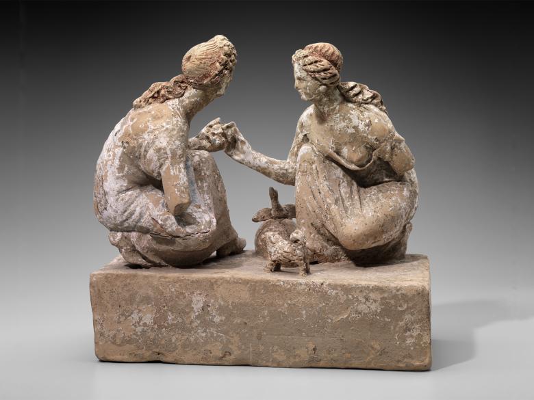 Terracotta sculpture of girls playing knucklebones game.
