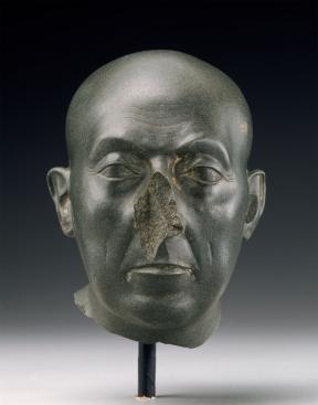 Green colored sculpture of a man's head