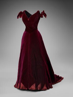 A burgundy, silk dress with bowed sleeves. 