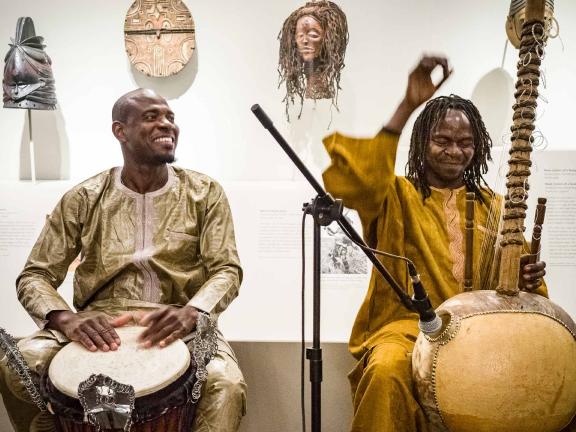 Two drummers performing in gallery