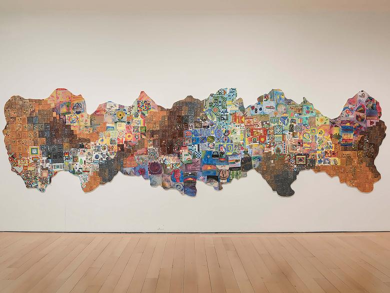 view of multicolored relief sculpture made up of smaller works of art created by grade school students