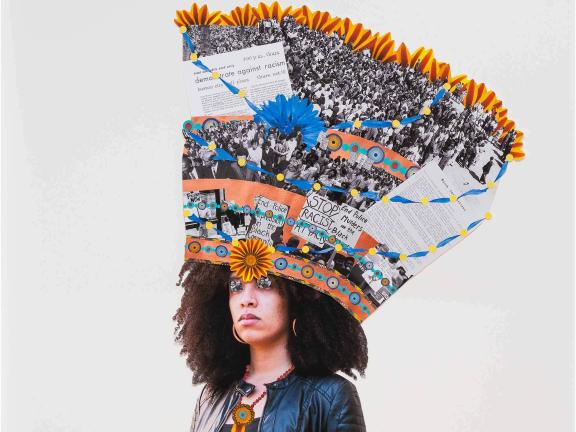 A person with a brightly colored headband and various images of people and protest signs coming out of the top of their head.