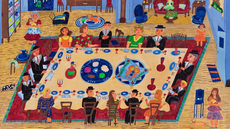 A family gathers around a large table to partake in seder during Passover. 