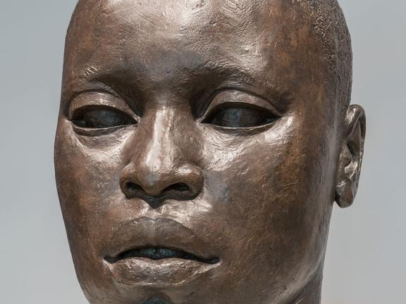 Sculpture of bronze head with African-American features and closely cropped hair