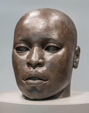 Sculpture of bronze head with African-American features and closely cropped hair